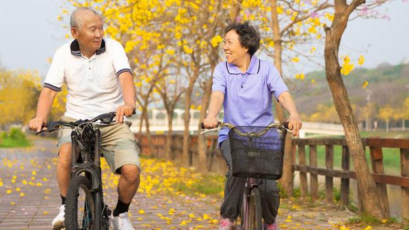 A Chinese man and woman on bicycles.