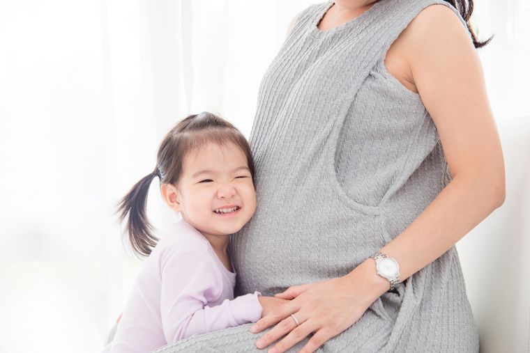 Pregnant Chinese woman and daughter